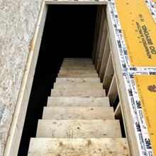 Luxury home under construction in Manchester, Vermont trapdoor showing stairs to the basement